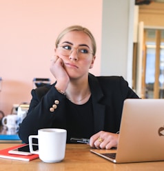 woman in black long sleeve shirt using macbook