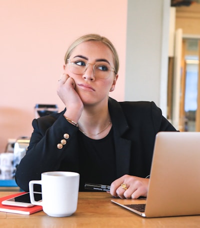 woman in black long sleeve shirt using macbook