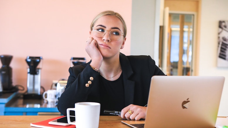 woman in black long sleeve shirt using macbook