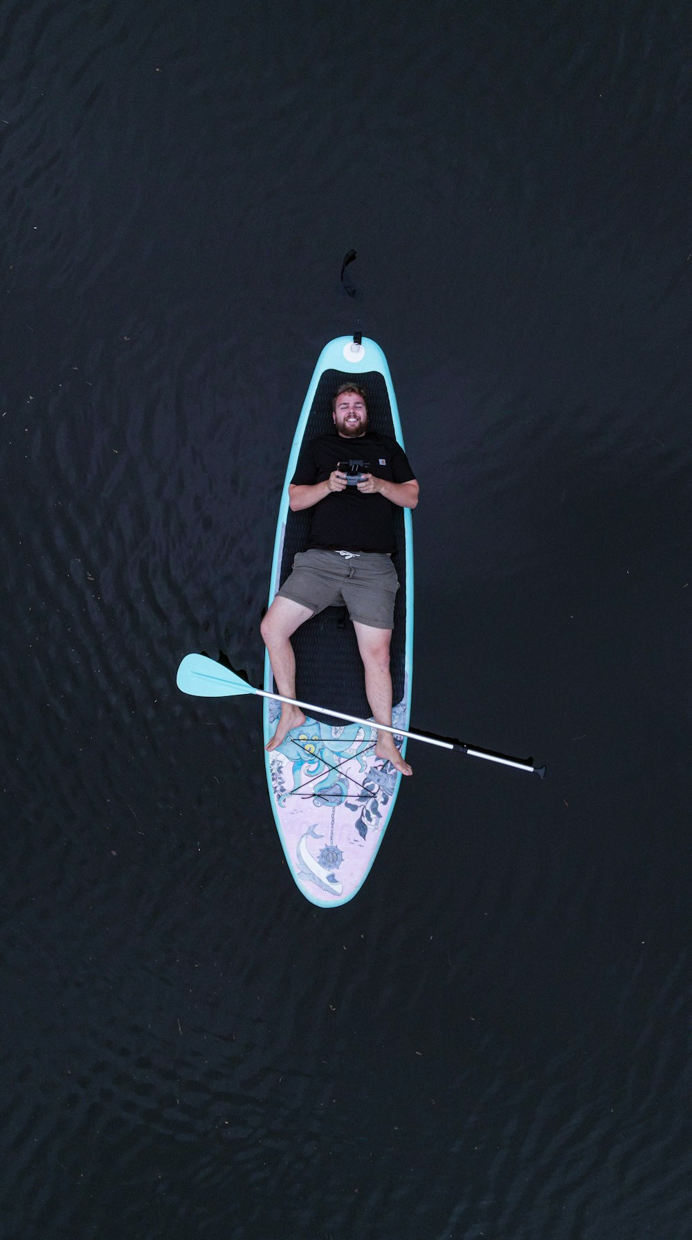 a man in a kayak floating on the water