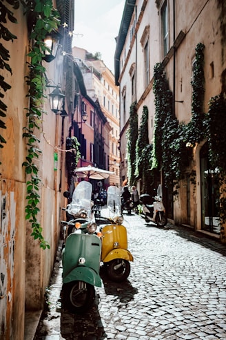 yellow and black motor scooter parked beside brown concrete building during daytime