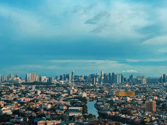 city skyline under blue sky during daytime in Manila Philippines
