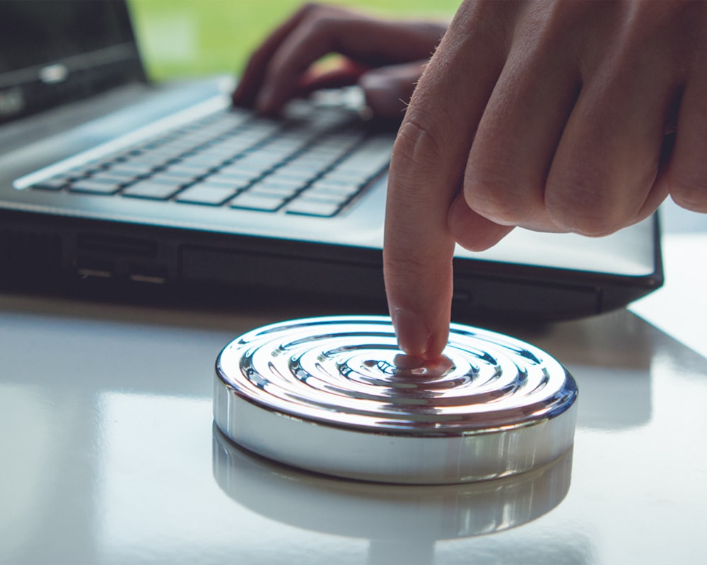 person holding clear glass round lid