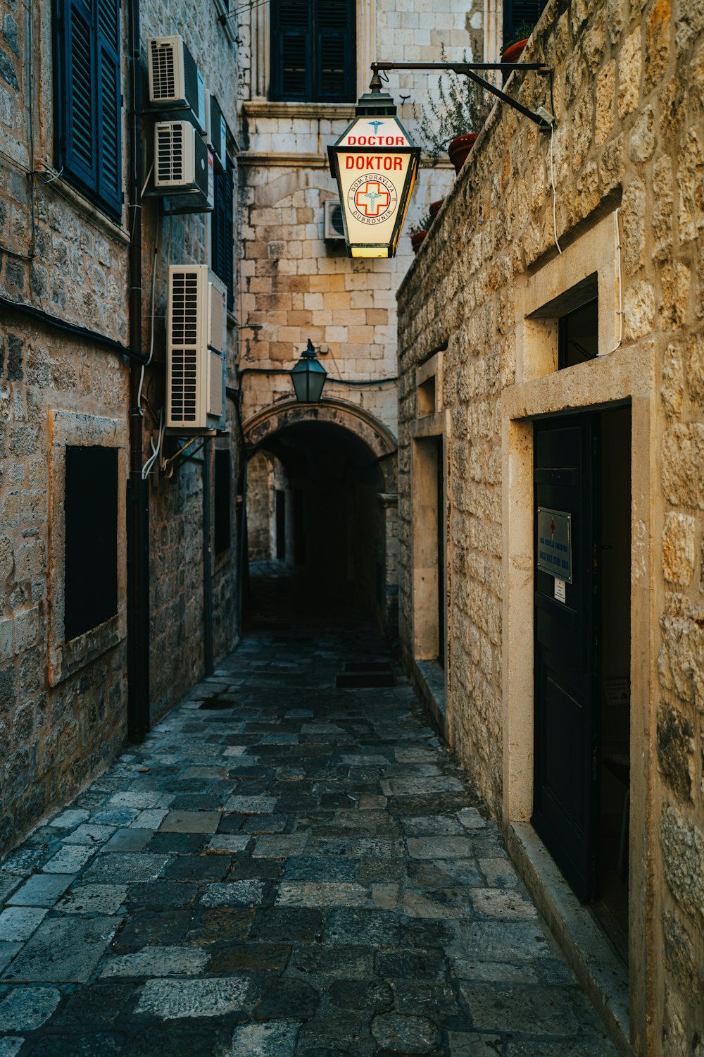 brown brick building with black wooden door