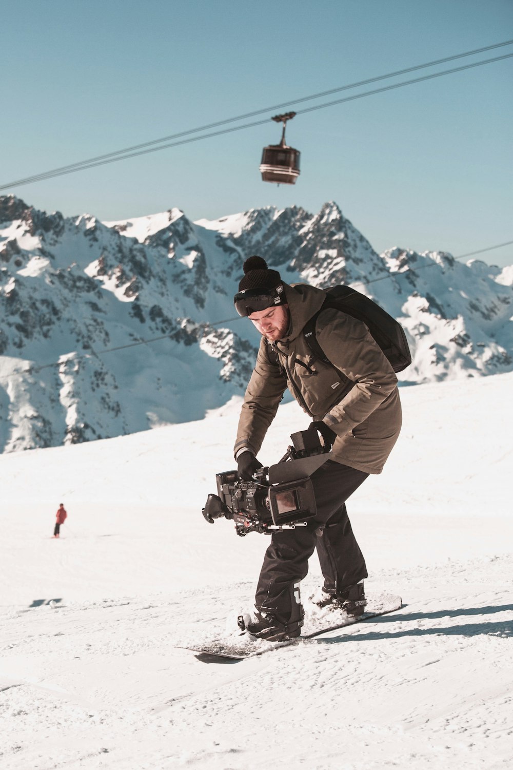 a man riding a snowboard down a snow covered slope