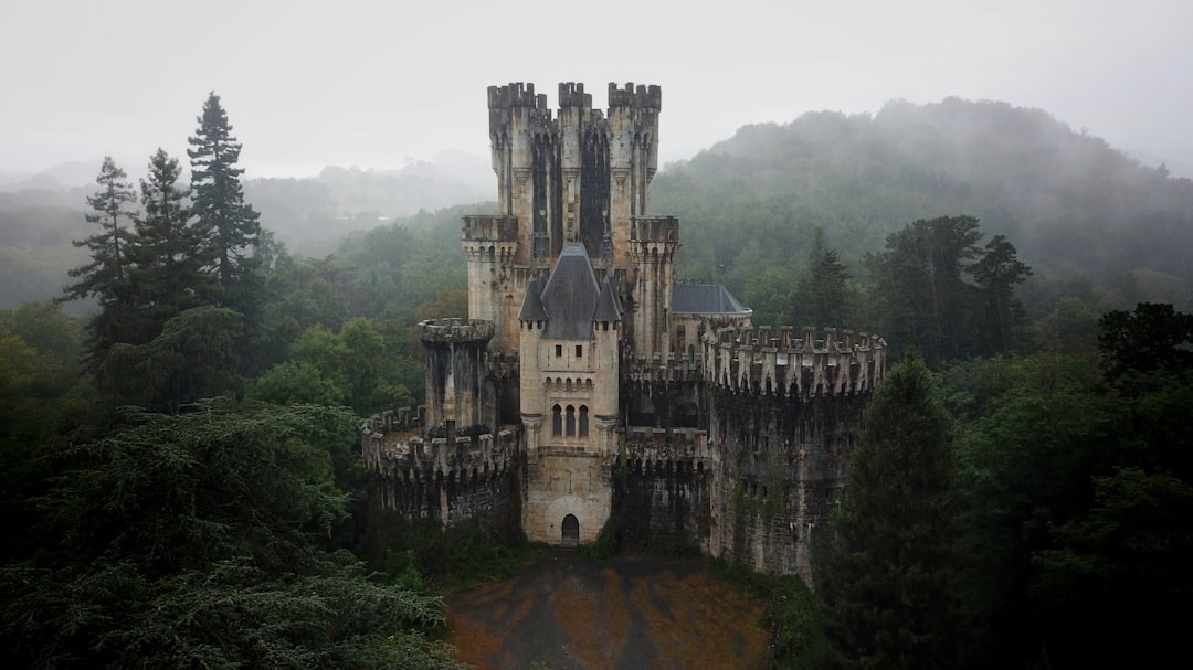 grey concrete castle on top of hill, A castle wrapped in fog in the north of spain
