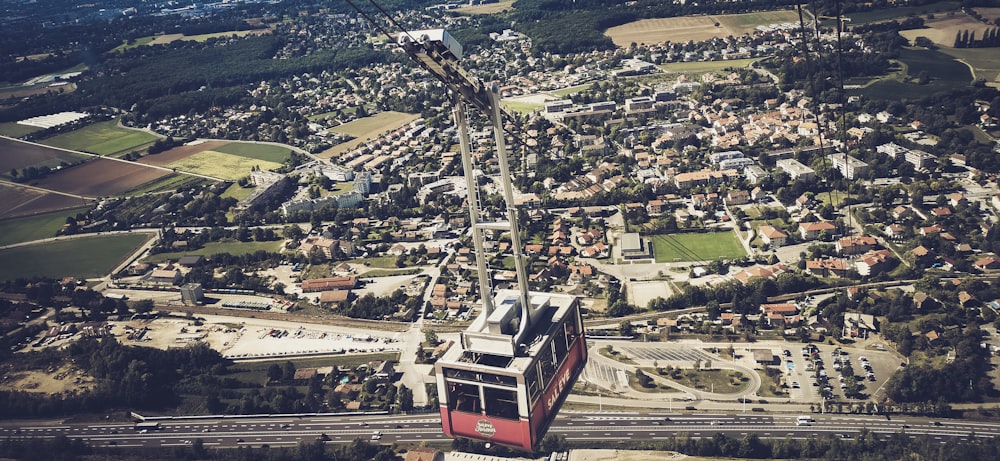 red and white cable car over city buildings during daytime