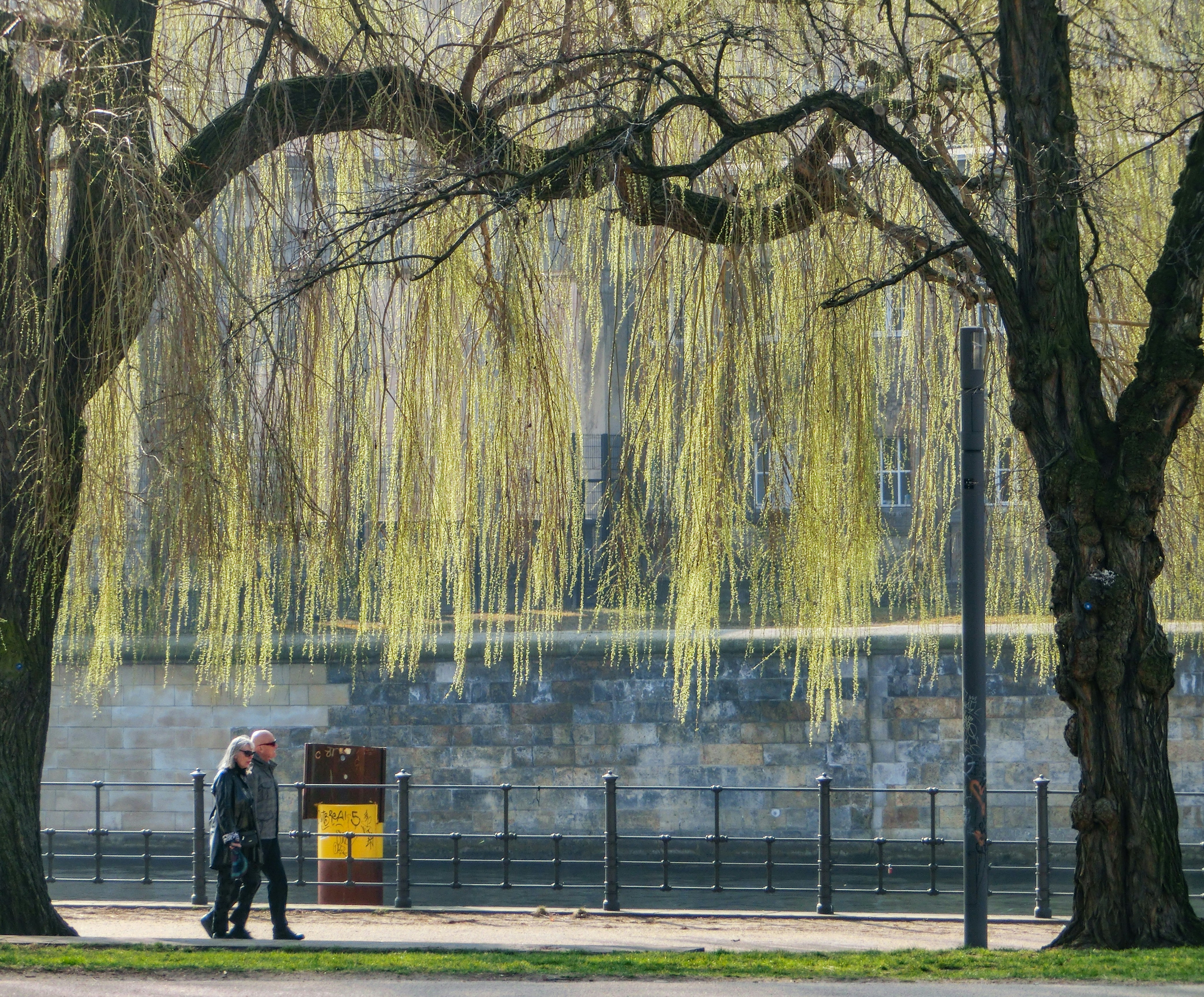 A elderly couple walking along the river in Berlin on saturday morning. 