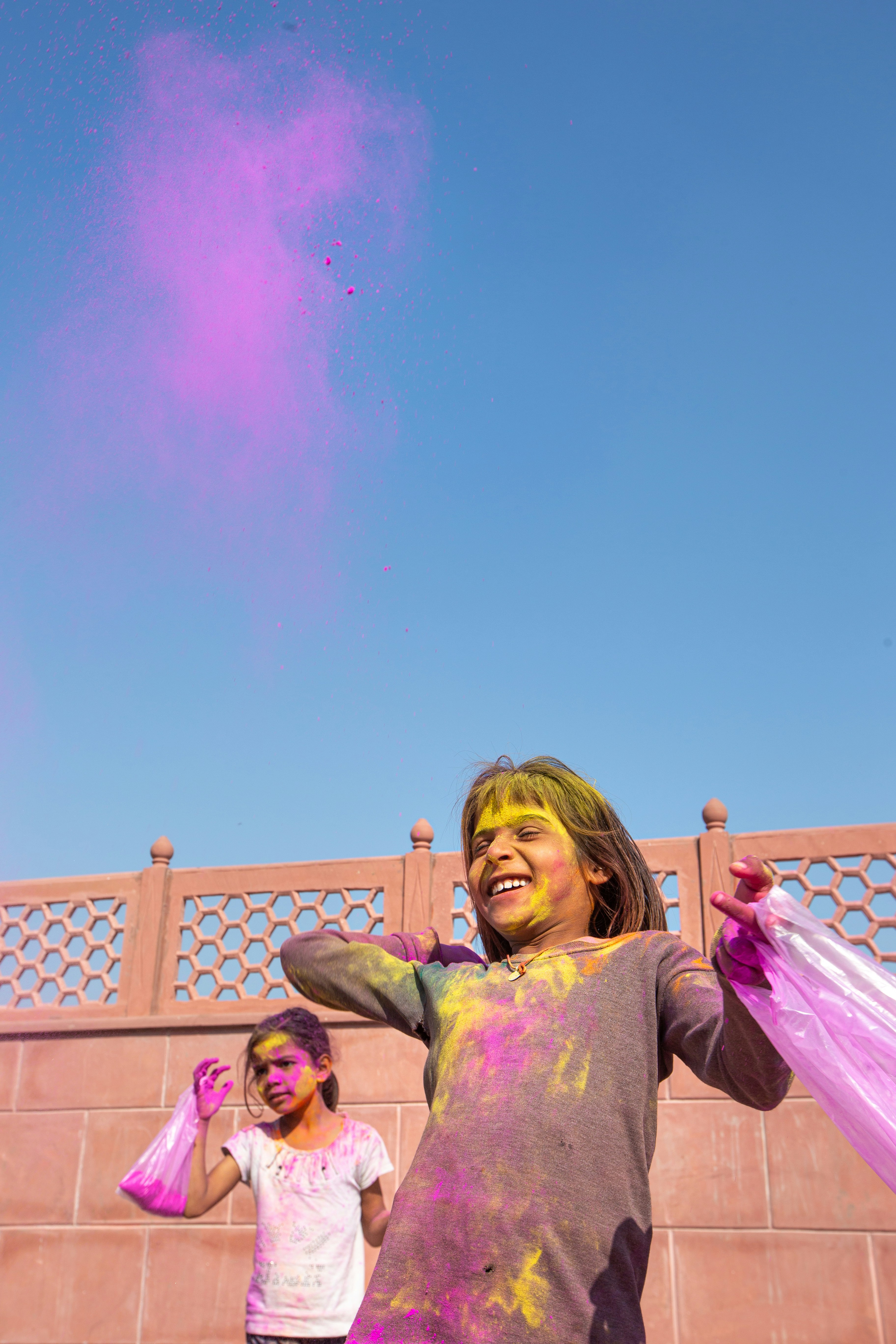 girl in pink long sleeve shirt holding pink umbrella