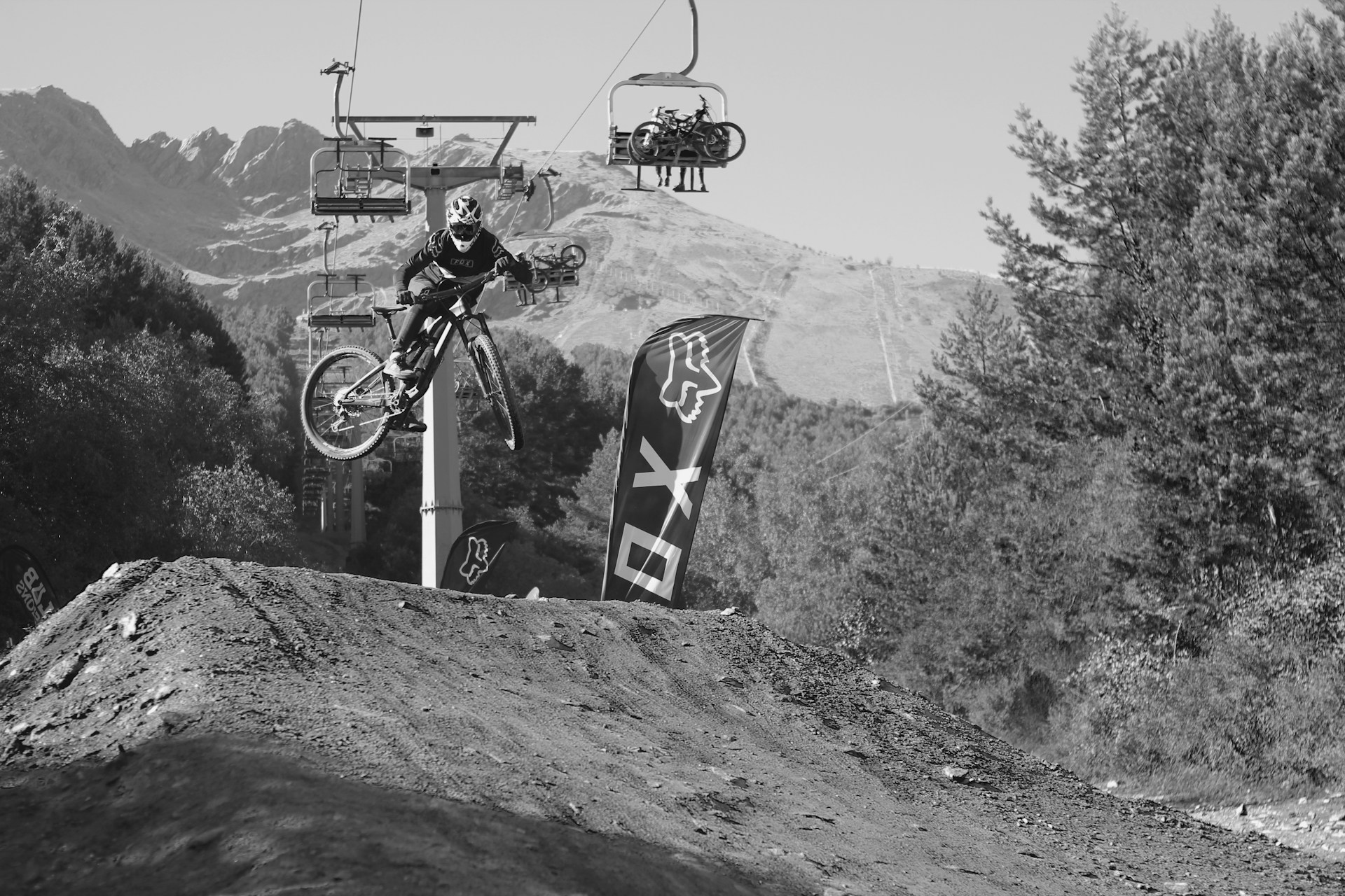 grayscale photo of man riding bicycle