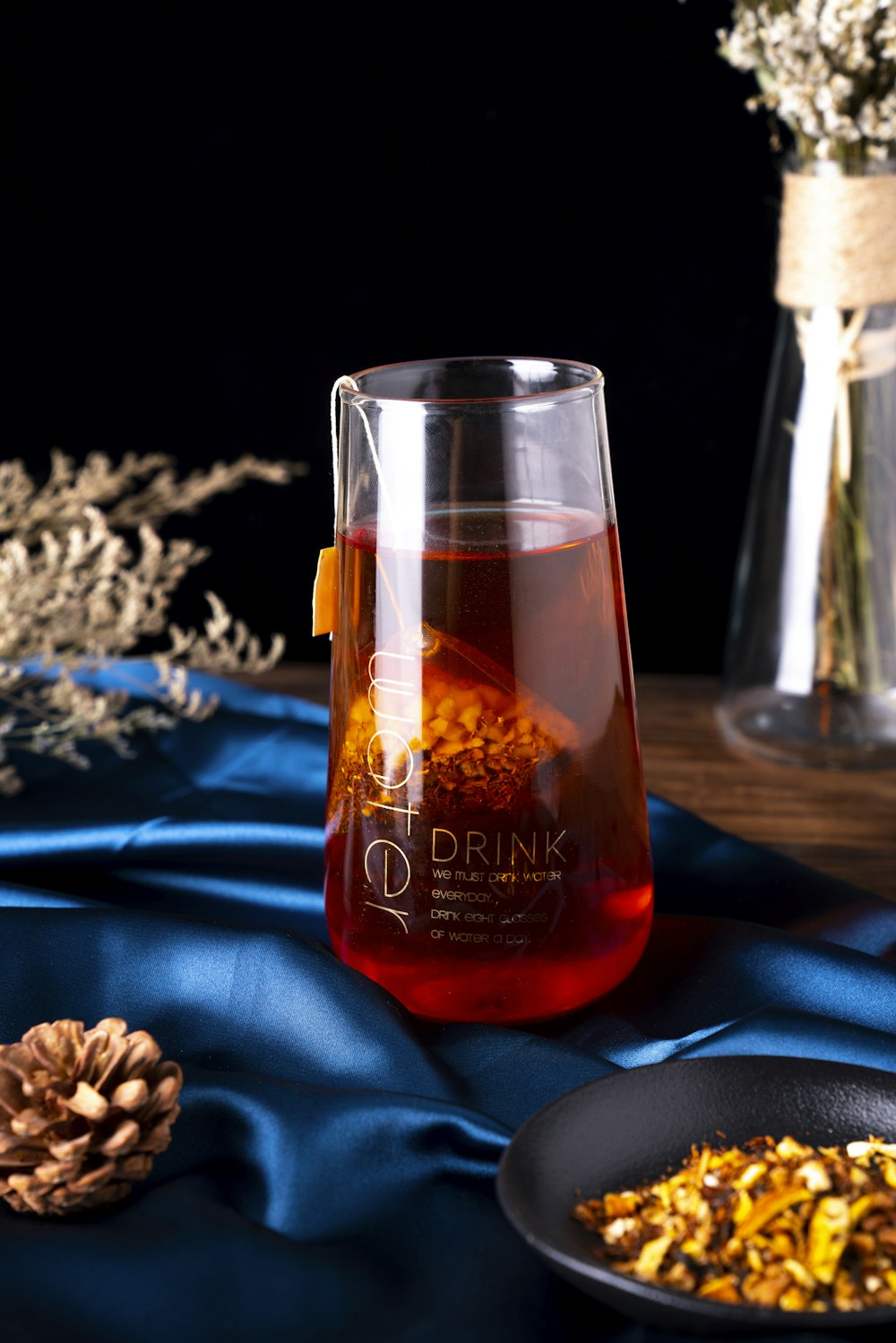 clear glass bottle on blue textile