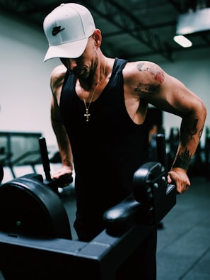 man in black tank top wearing white cowboy hat