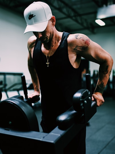 man in black tank top wearing white cowboy hat