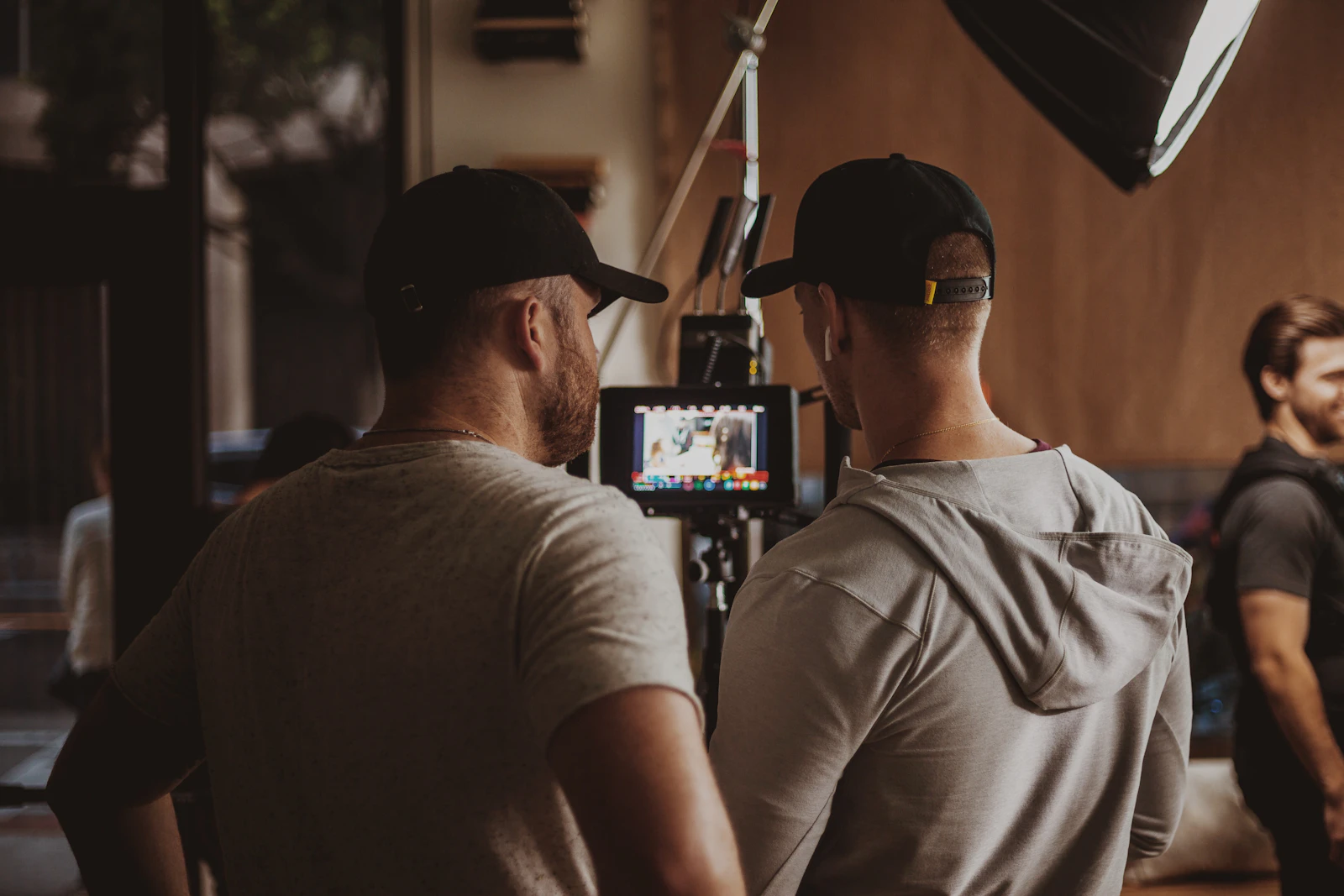 Two crew members checking a monitor on set