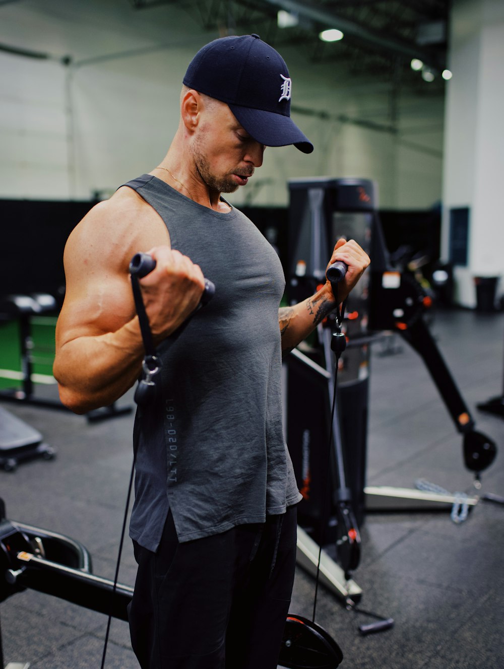 man in gray crew neck t-shirt and black pants holding black smartphone