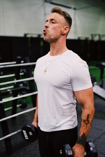 man in white crew neck t-shirt and black shorts