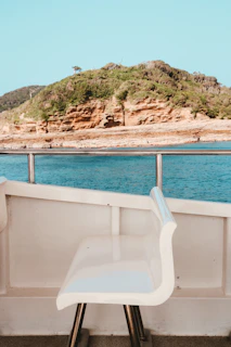 A luxurious white marine cushion perfectly fitted on a boat bench under bright sunlight.