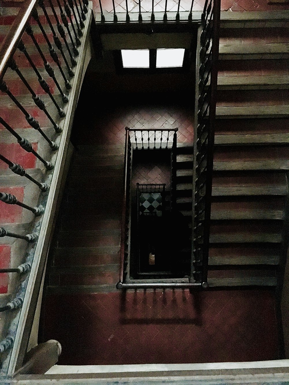 brown wooden staircase with black steel railings