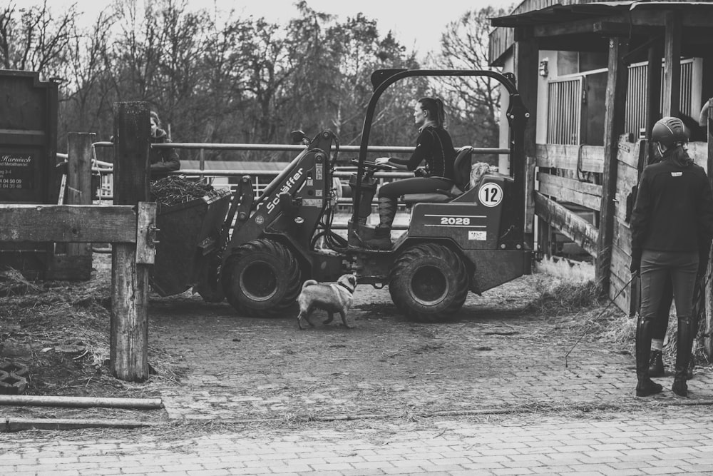 grayscale photo of a man driving a truck