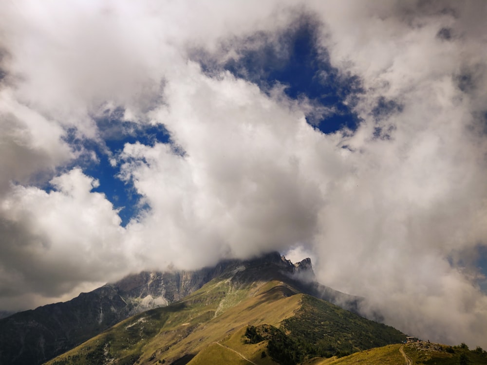 green mountain under white clouds during daytime