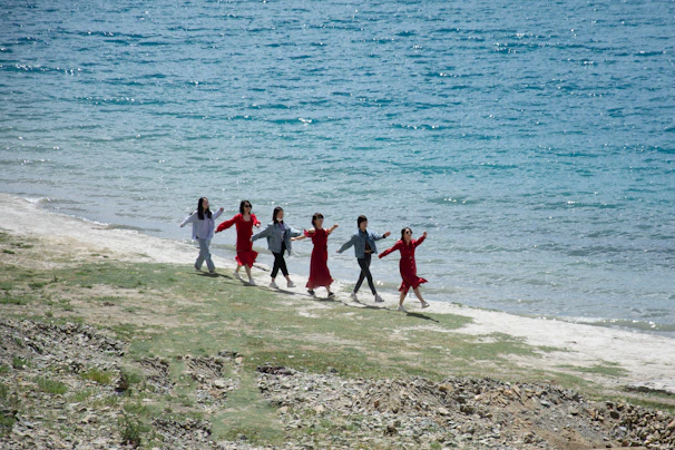 Group of friends enjoying a lively shared moment during a shore excursion.