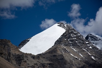 A sleek, icy mountain peak under a clear blue sky symbolizing the cold, northern inspiration of Nortiq.