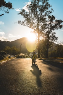 Action shot of a rider zooming down a dirt trail on a rugged mini motorbike at sunset.