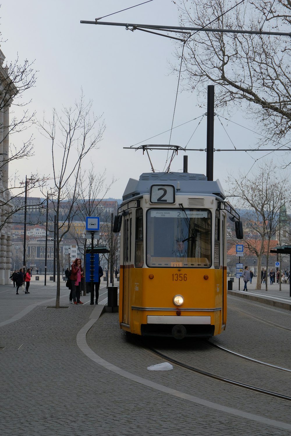 yellow and white tram on road during daytime