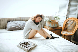 A person happily printing a simple letter in a cozy home environment.