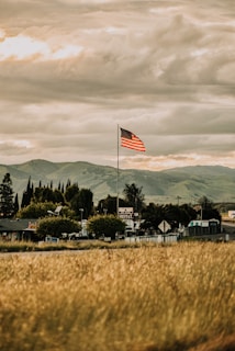 us a flag on green grass field during daytime