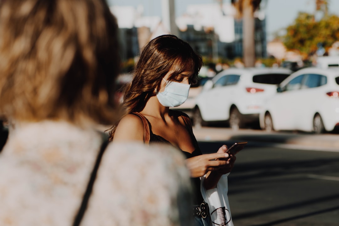 woman in white brassiere and white gloves holding smartphone