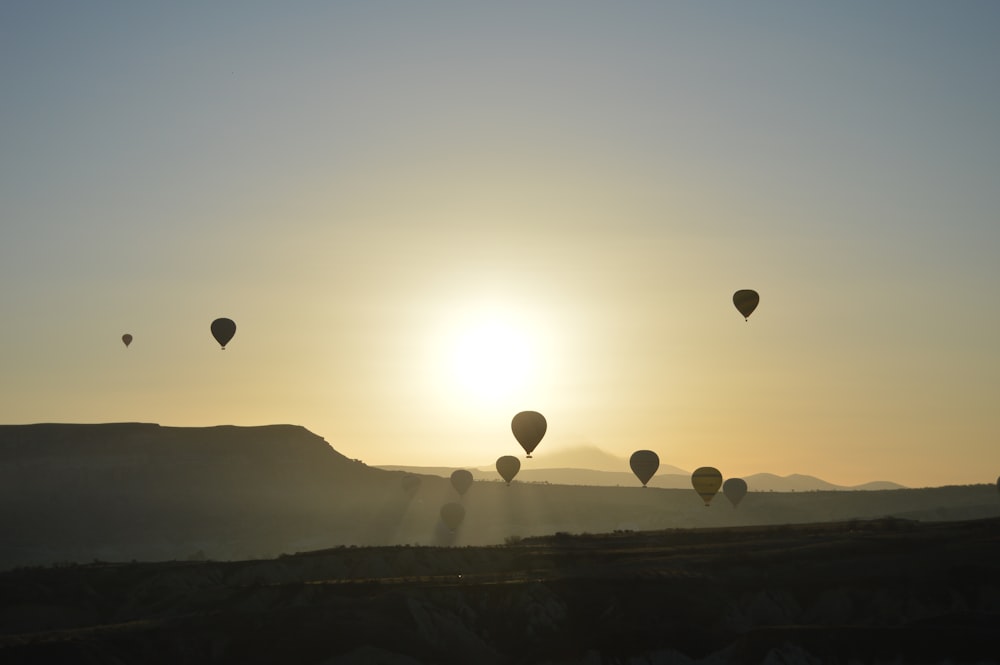 silhouette of hot air balloons during sunset