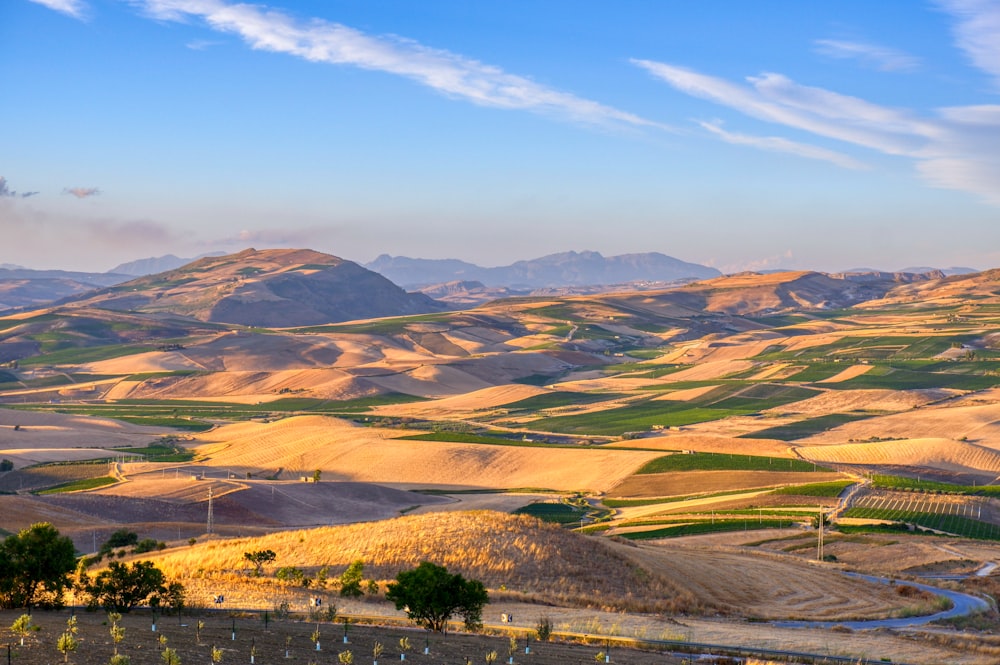 green and brown mountains under blue sky during daytime