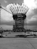 A panoramic shot of a massive construction site with towering steel frameworks under a moody sky.
