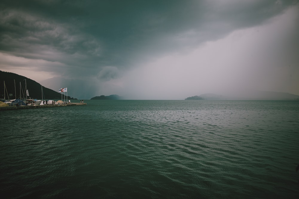 body of water under cloudy sky during daytime