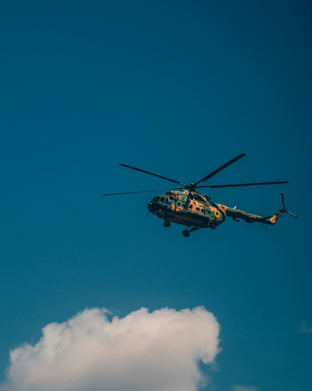 brown helicopter flying in the sky during daytime