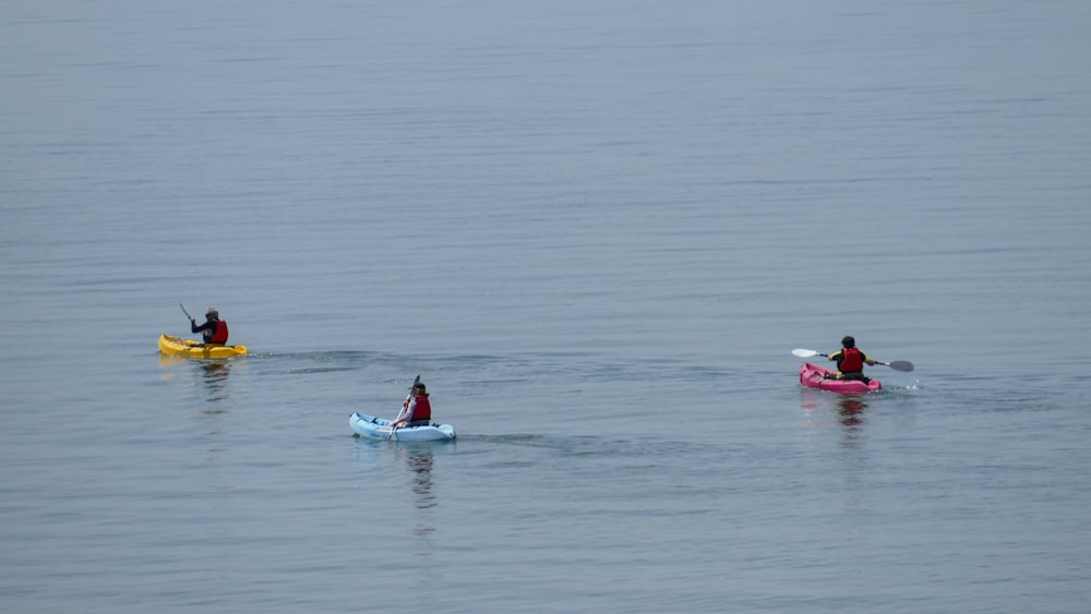 man in red shirt riding red kayak on sea during daytime
