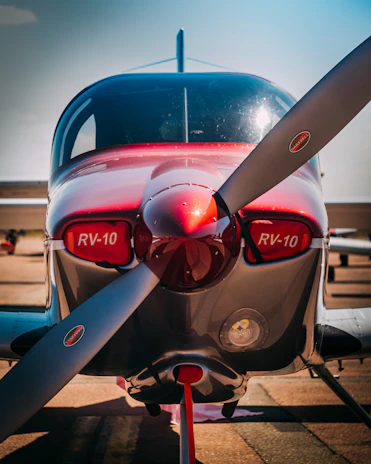 Photo of John Michael Greiner standing proudly beside the Velocity 173 SE-RG Elite aircraft.