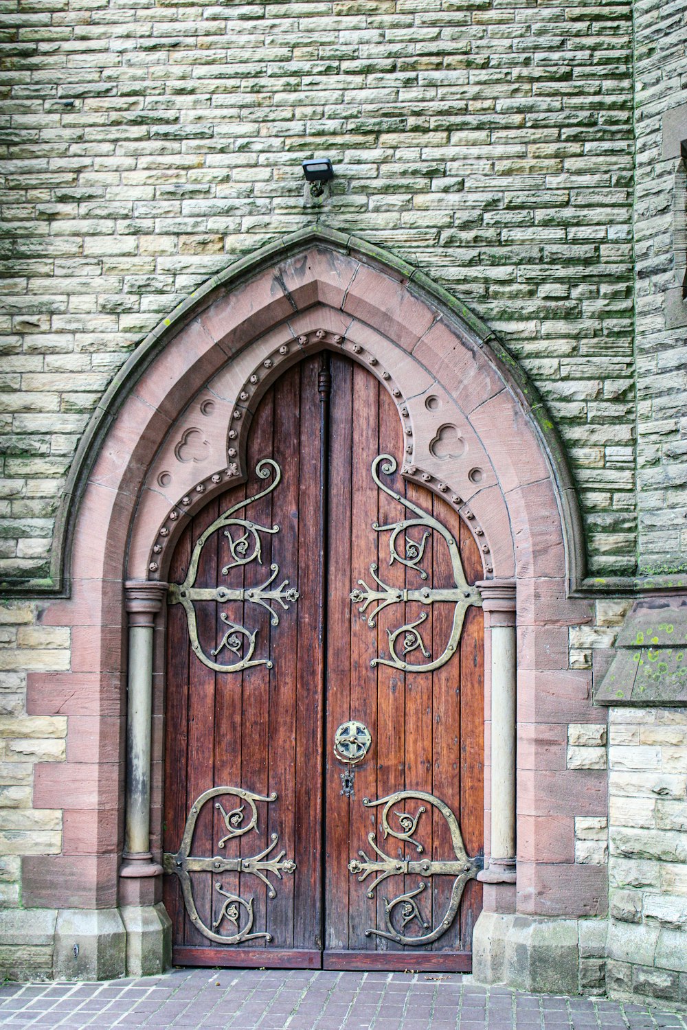 brown wooden door on brown brick wall