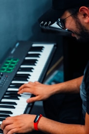 man in blue denim jacket playing piano