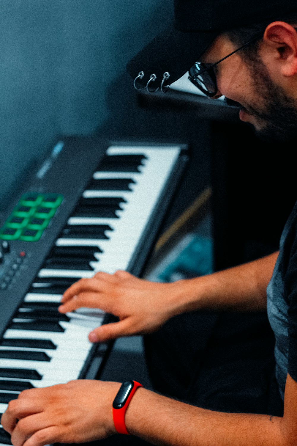 man in blue denim jacket playing piano