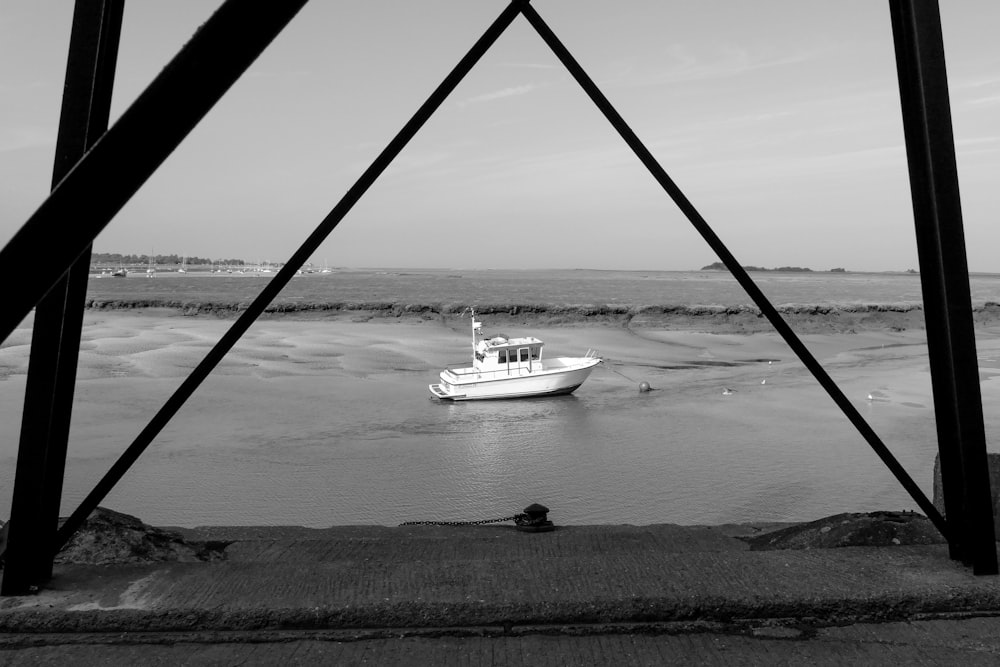 grayscale photo of white boat on water