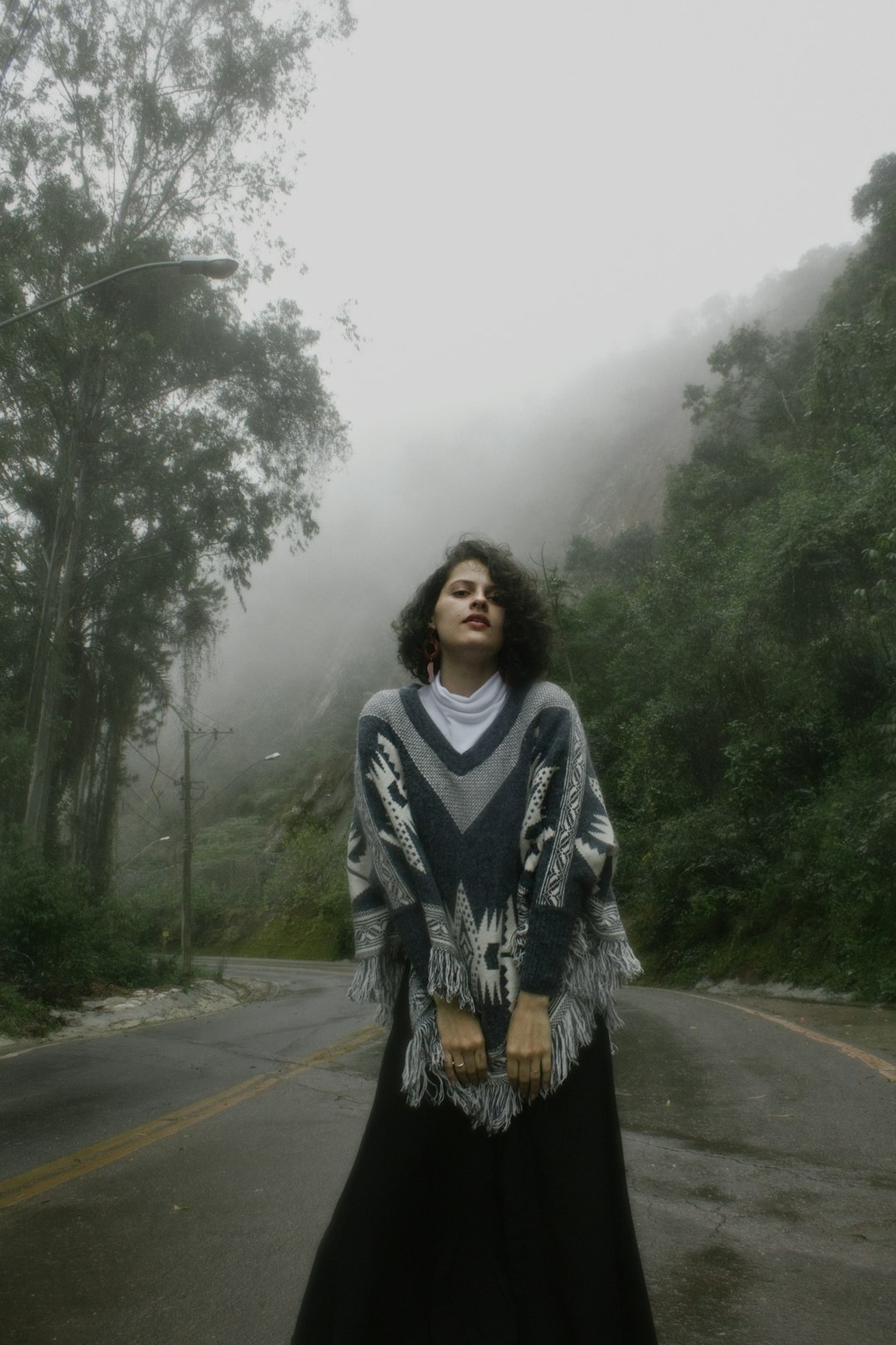 woman in black and white long sleeve shirt standing on road