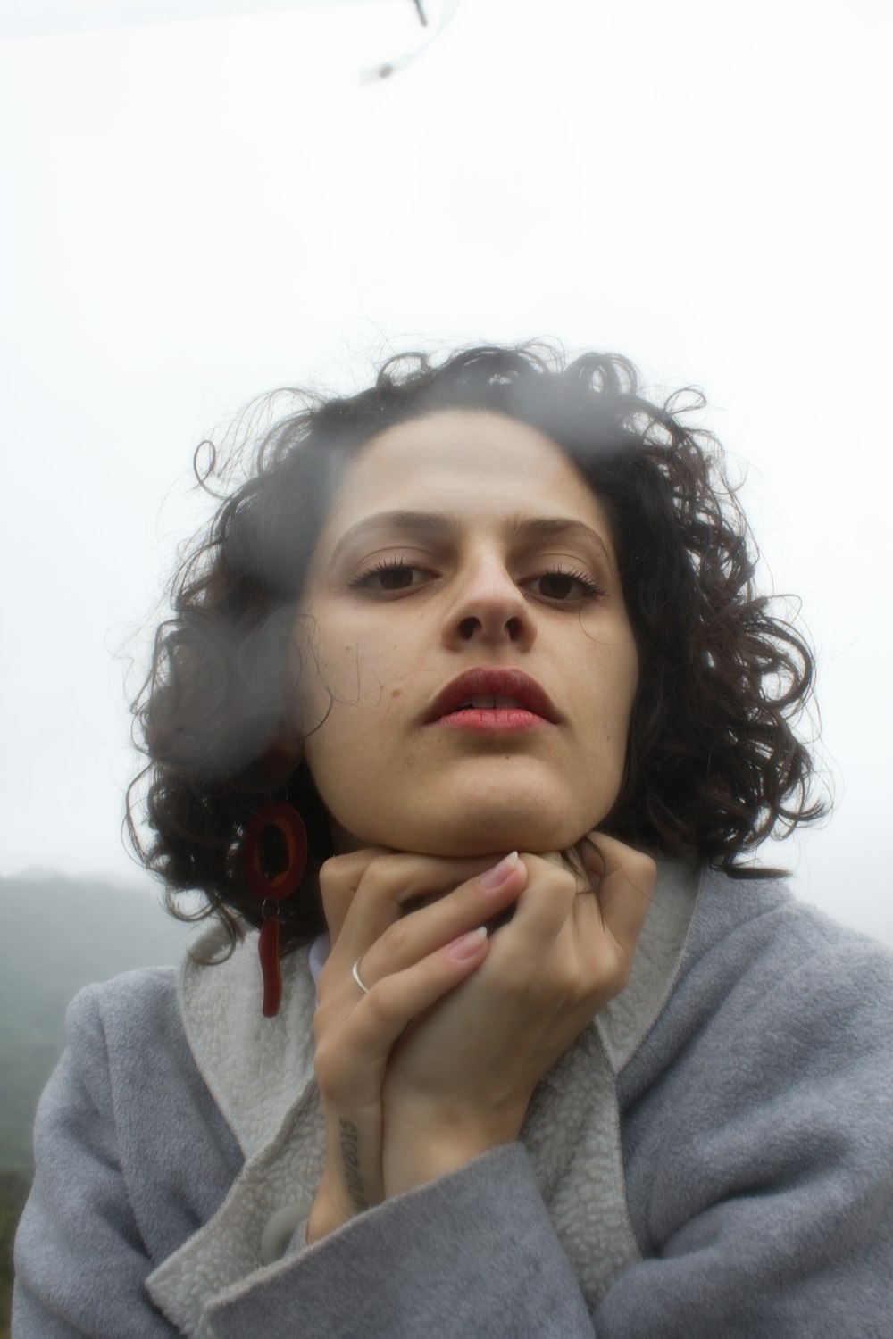 girl in gray hoodie with red lipstick