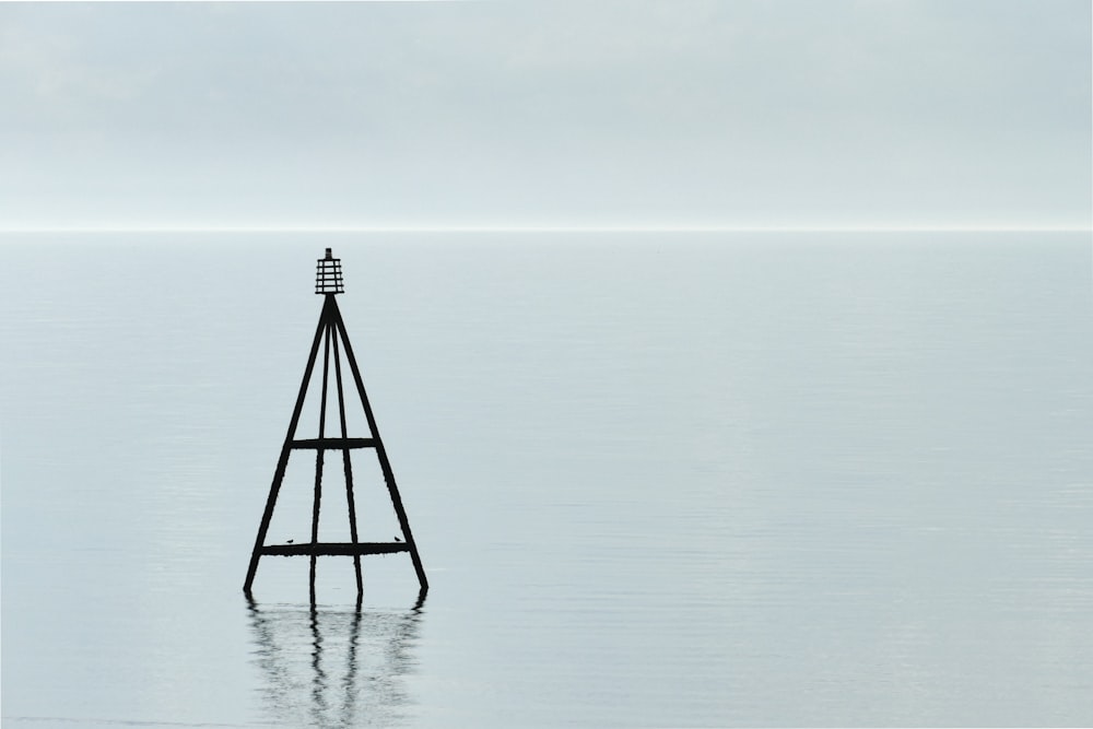 black metal stand on body of water