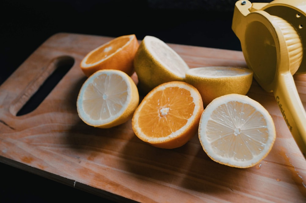 sliced lemon on brown wooden chopping board