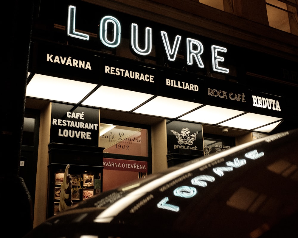 a restaurant called louvre lit up at night