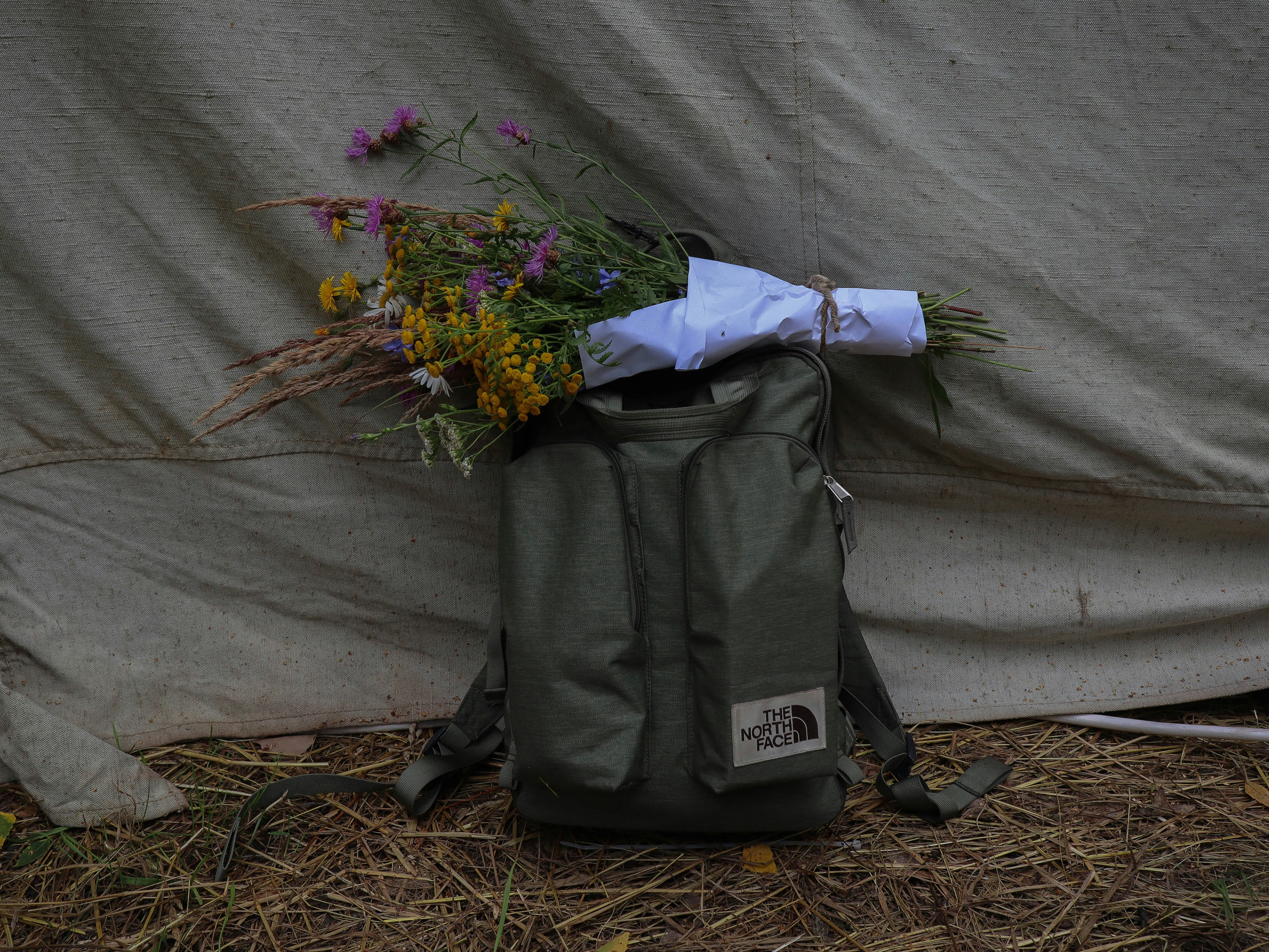 green and yellow flower bouquet on black and gray backpack