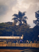 Team members from Guinchos 4 Amigos helping a stranded driver beside a highway under a cloudy sky