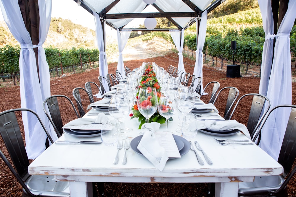 white table with white table cloth and chairs